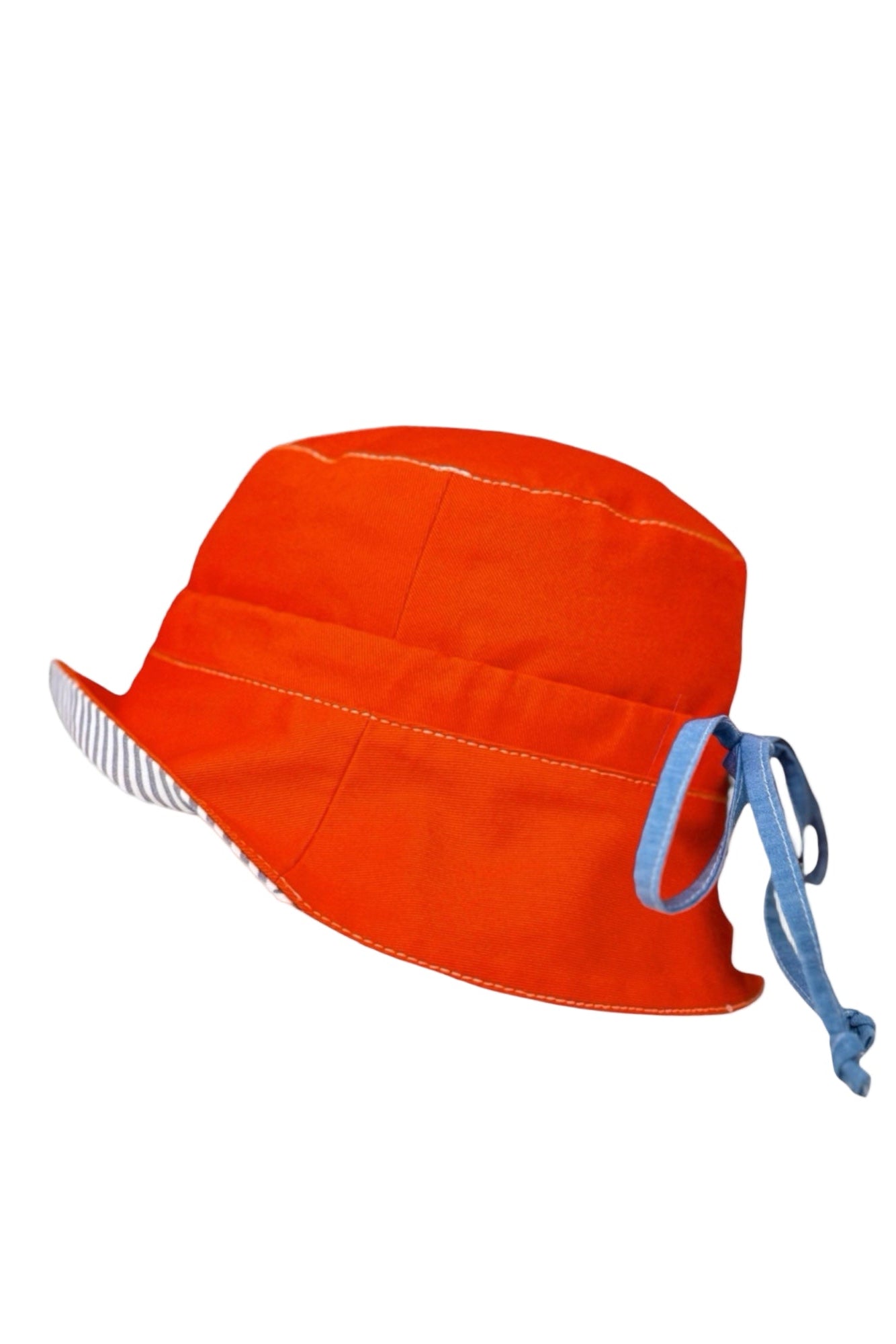 Introducing our versatile summer hat in deep orange denim featuring a stylish combination of white and navy striped cotton. The slim tie on the back allows for adjustable sizing, ensuring a perfect fit. Embrace the warmth of the sun while looking effortlessly chic.  DETAILS AND CARE  Fabric - denim 100% cottoton, &nbsp;70% Ramie 30% cotton  Hand wash