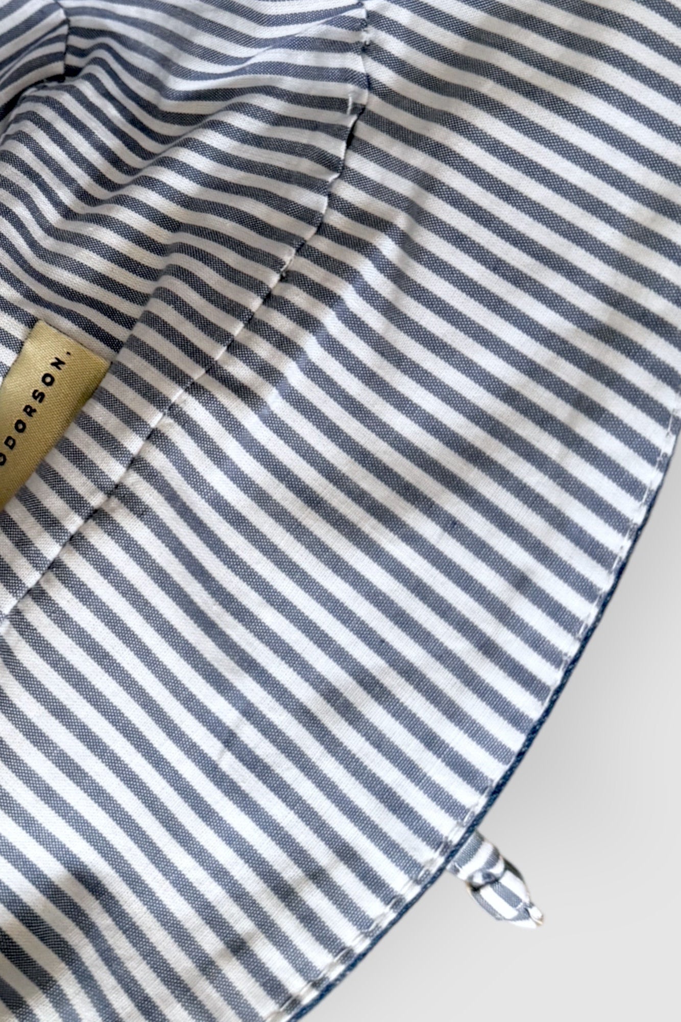 Introducing our versatile denim summer hat featuring a stylish combination of white and navy striped cotton. The slim tie on the back allows for adjustable sizing, ensuring a perfect fit. Embrace the warmth of the sun while looking effortlessly chic.  DETAILS AND CARE  Fabric - 100% cotton  Hand wash