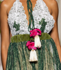 Long women’s jumpsuit with lace bodice, floral details, decorative ties, tassels and wide-leg trousers.