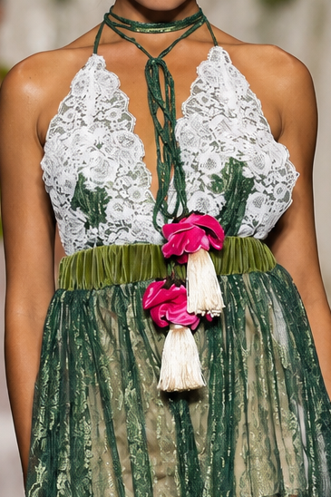 Long women’s jumpsuit with lace bodice, floral details, decorative ties, tassels and wide-leg trousers.