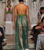 Long women’s jumpsuit with lace bodice, floral details, decorative ties, tassels and wide-leg trousers.