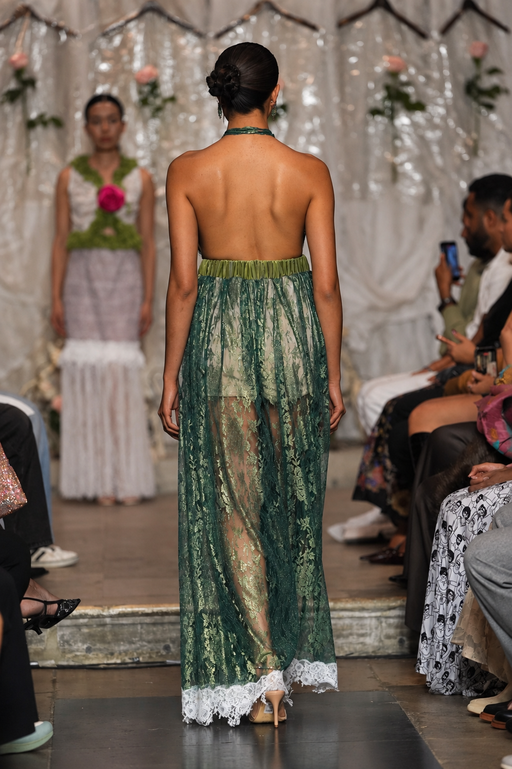 Long women’s jumpsuit with lace bodice, floral details, decorative ties, tassels and wide-leg trousers.