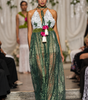Long women’s jumpsuit with lace bodice, floral details, decorative ties, tassels and wide-leg trousers.