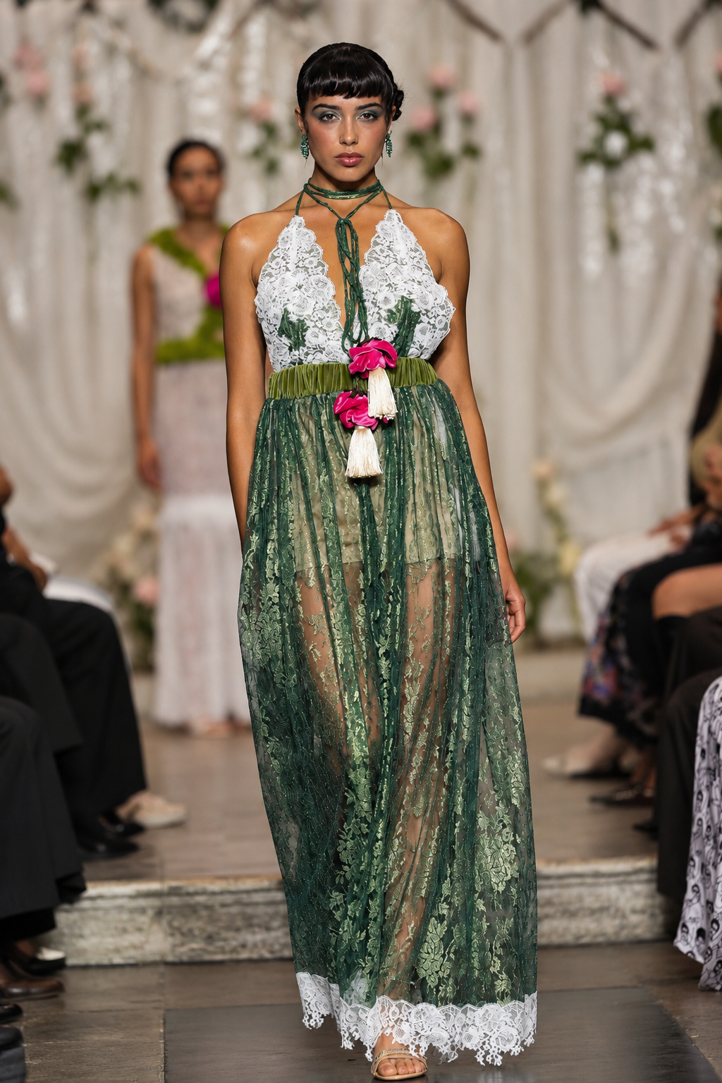 Long women’s jumpsuit with lace bodice, floral details, decorative ties, tassels and wide-leg trousers.