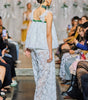 Long lace jumpsuit with relaxed bodice, floral accents and wide-leg trousers.