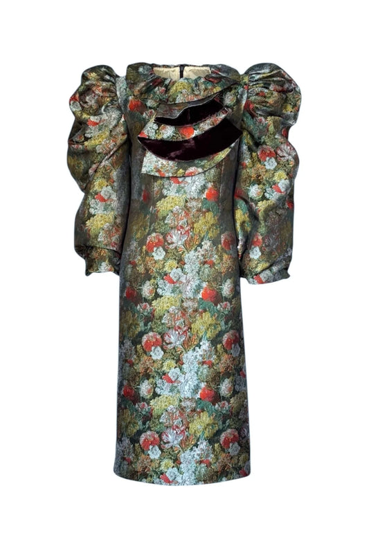 Floral patterned dress with a large bow on a white background