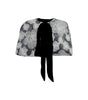 Floral patterned cape with a black tie on a white background