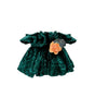 Green velvet dress with a floral detail on a white background