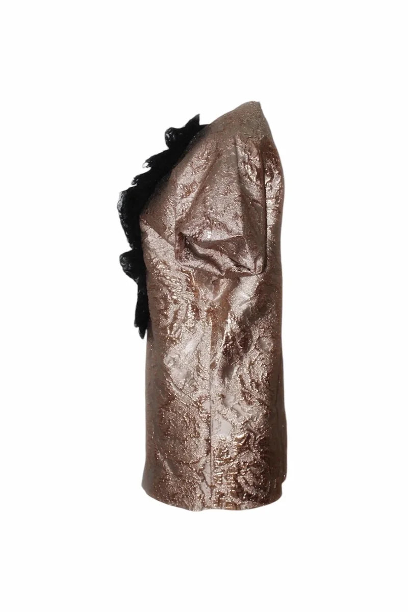 Metallic gold jacket with black ruffle details on a white background