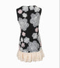 Black strapless dress with floral lace design and white ruffle hem on a white background