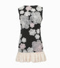 Black dress with floral patterns and white ruffled hem on a white background
