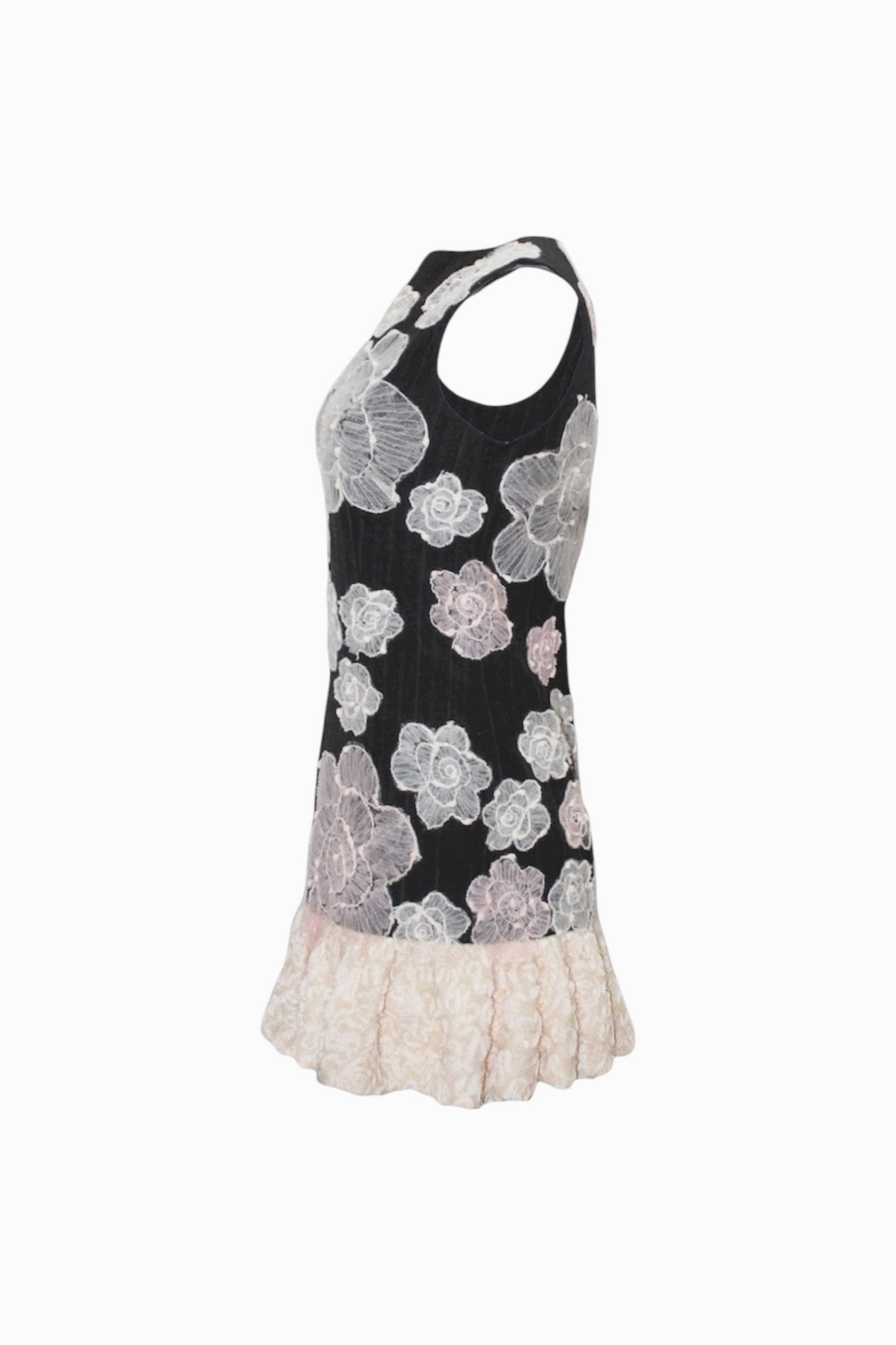 Black dress with floral patterns and white lace trim on a white background
