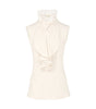 White sleeveless top with a high neckline on a white background