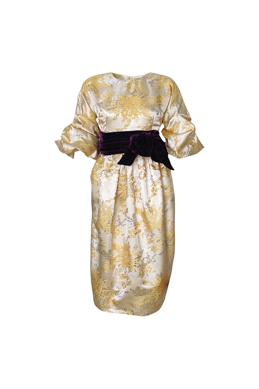 Gold patterned dress with a purple belt on a white background