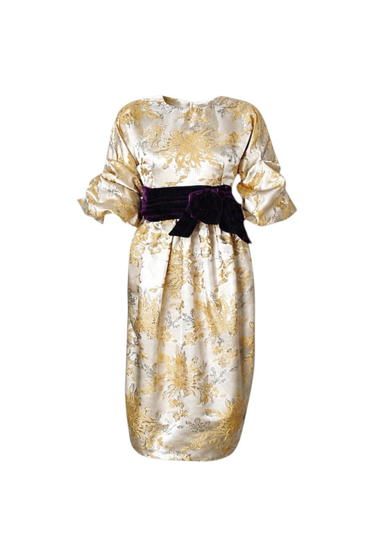 Gold and white floral dress with a purple belt on a white background