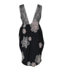 Black dress with floral lace details on a white background