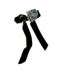 Black ribbon with a floral bow on a white background
