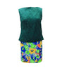 Green sleeveless top and colorful floral skirt on a white background