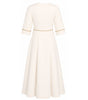 White dress with gold trim on a white background