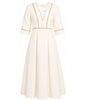 White dress with gold trim on a white background
