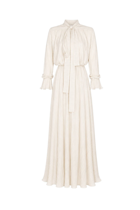 White dress with long sleeves and a tie neckline on a white background