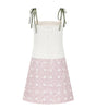 Dress with white top and pink polka dot skirt on a white background