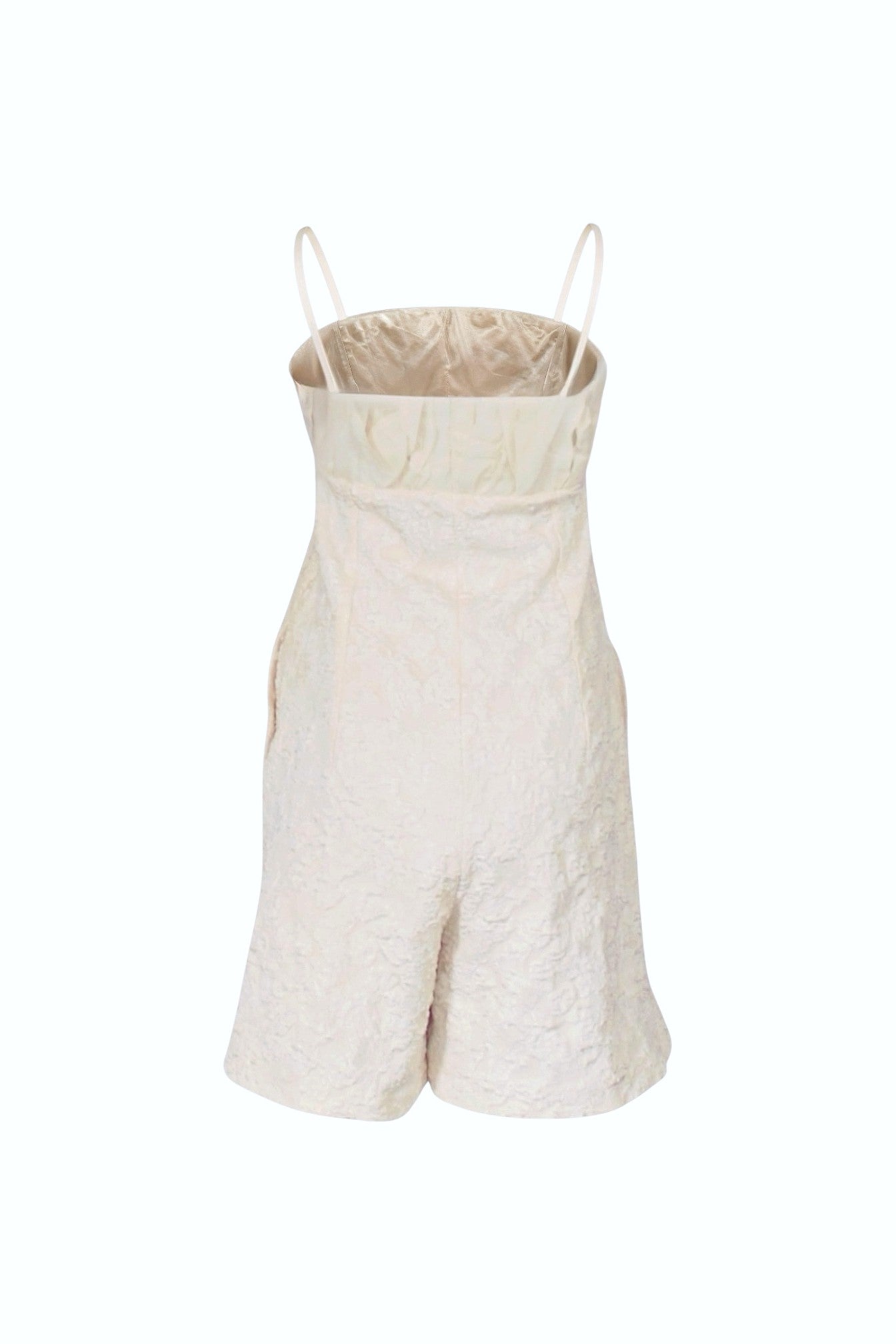 Beige romper with thin straps on a white background