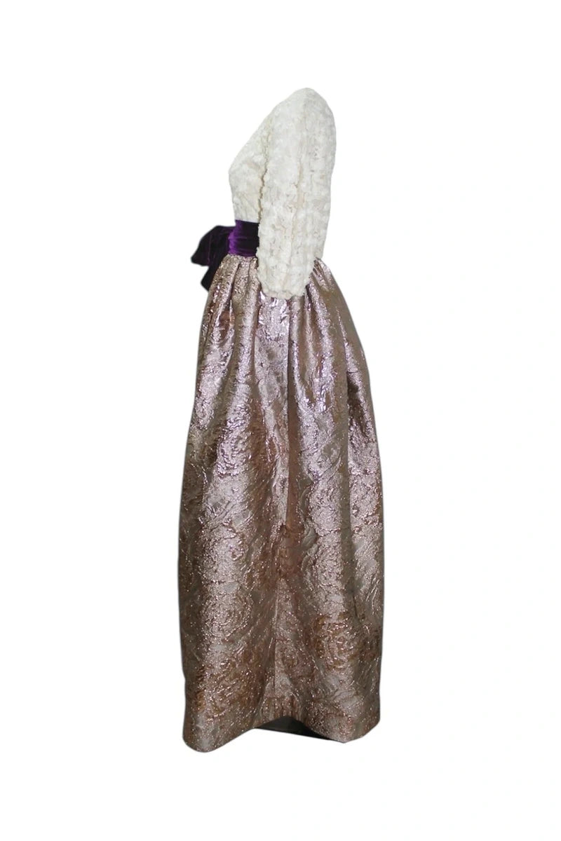 Costume with metallic skirt and white hood on a white background