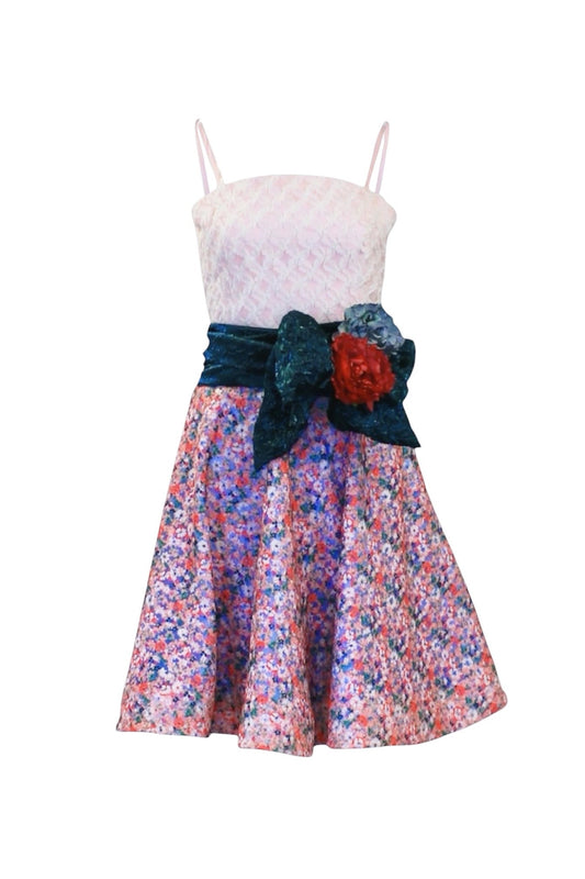 Dress with floral skirt and decorative bow on a white background