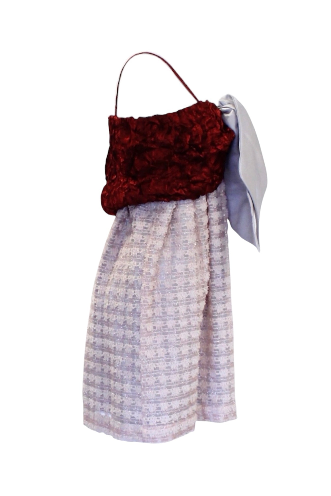 Dress with a textured red top and patterned skirt on a white background