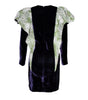 Black dress with green floral sleeves on a white background