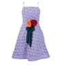 Purple lace dress with floral decorations on a white background