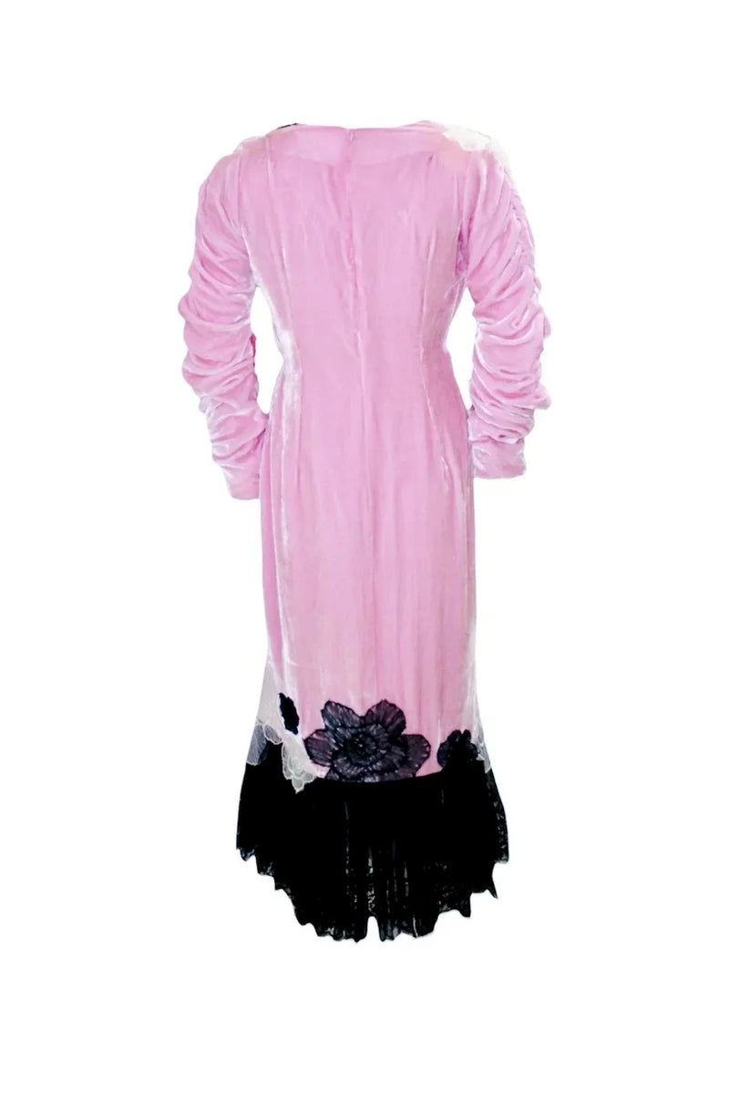 Pink dress with black floral hem on a white background