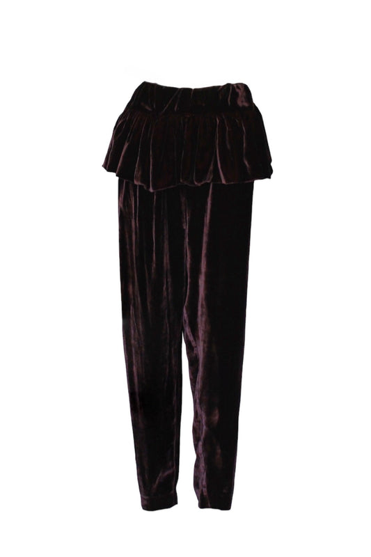 Pair of dark purple velvet pants with a ruffled top on a white background