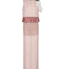 Pink dress with polka dot top and textured skirt on a white background