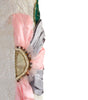 Decorative arm sleeve with pink and gray fabric and embellishments on a white background